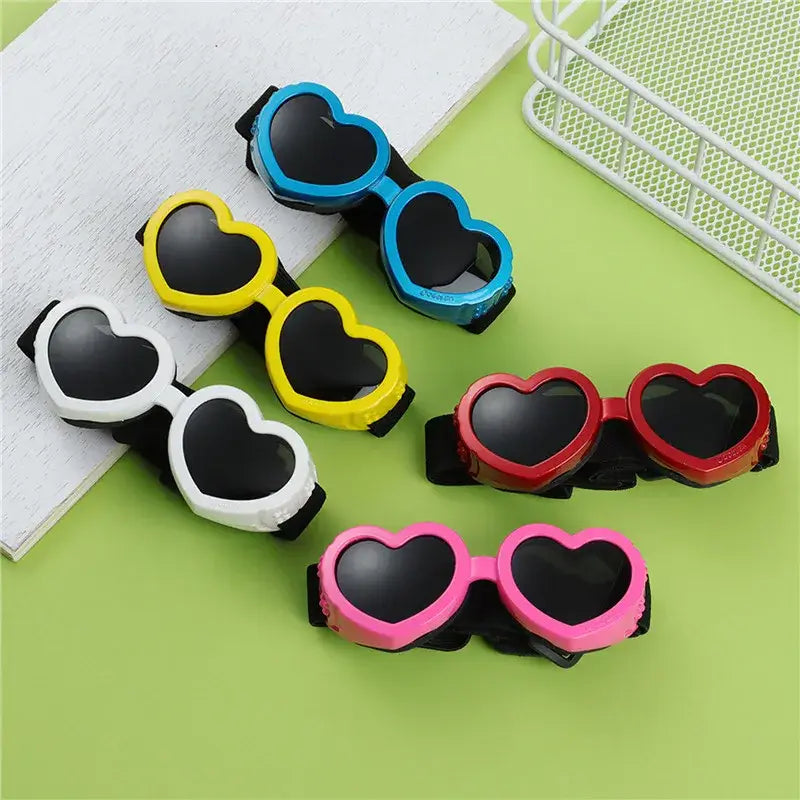 Heart-shaped dog sunglasses with adjustable strap for small pets, UV protection goggles in multiple colors