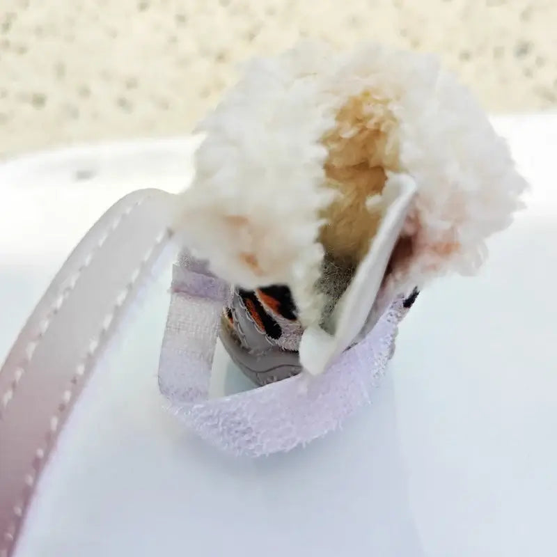 Inside view of winter leopard boots for small dogs, showcasing soft plush lining and Velcro strap.