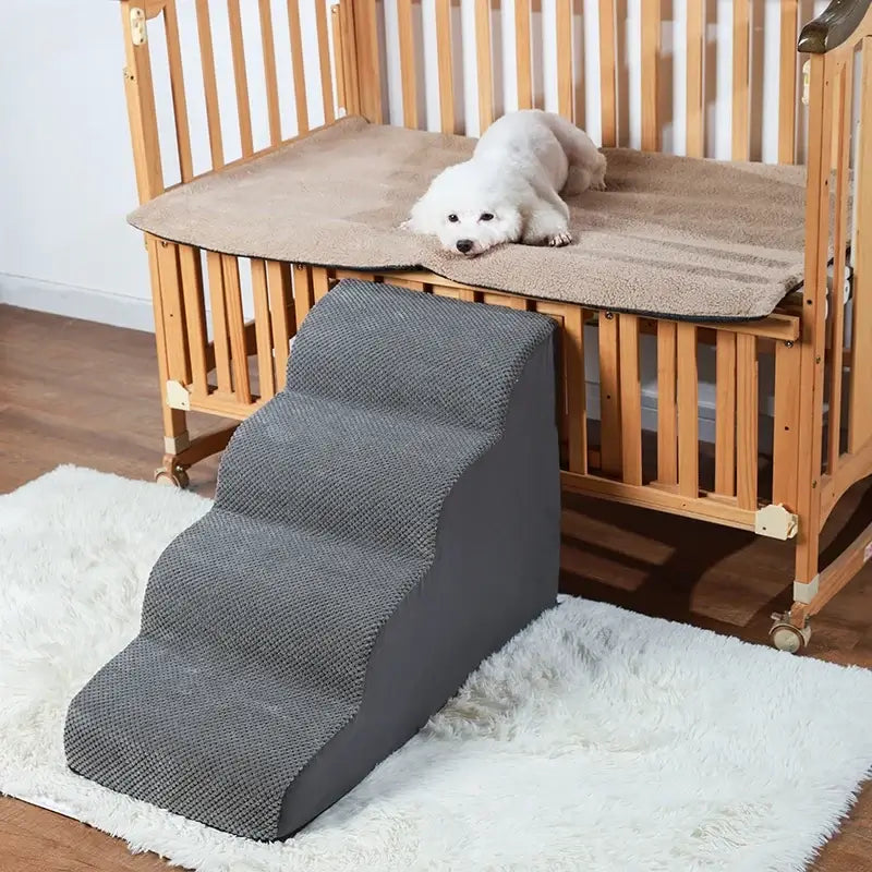 memory foam dog stairs for small pets placed beside a pet bed for easy access, featuring a grey color design.