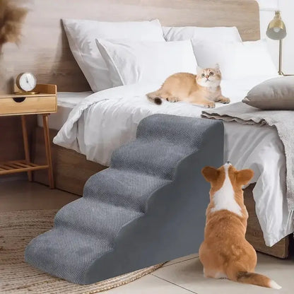 memory foam dog stairs for small pets placed beside a bed with a dog and a cat.