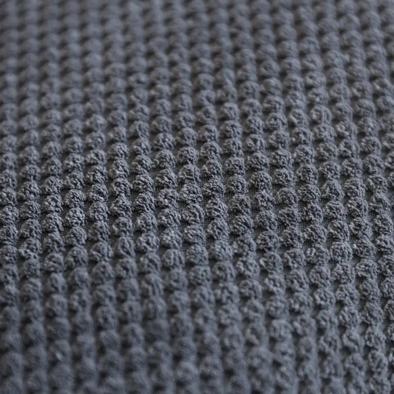Close-up view of textured dark gray fabric, ideal for pet accessories like memory foam dog stairs for small pets.