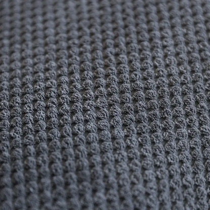 Close-up view of textured dark gray fabric, ideal for pet accessories like memory foam dog stairs for small pets.