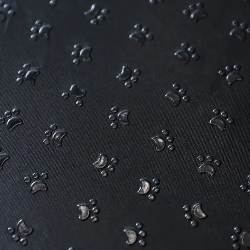 Textured black surface with embossed paw prints for memory foam dog stairs for small pets.