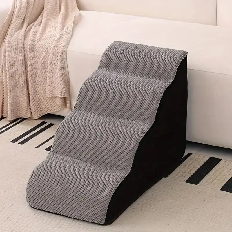memory foam dog stairs for small pets placed near a couch for easy access and comfort.