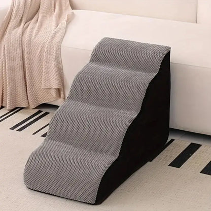 memory foam dog stairs for small pets placed near a couch for easy access and comfort.