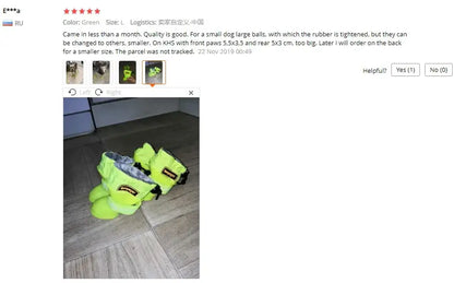 Waterproof dog rain boots in green color for small dogs, displayed on a floor.