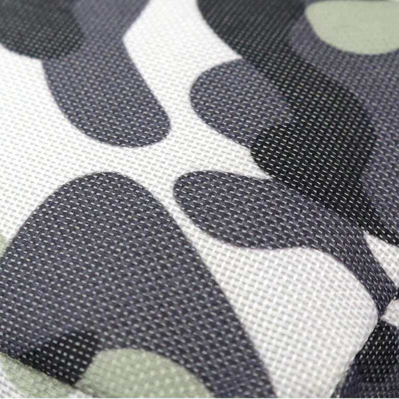 Patterned fabric close-up showcasing textured nylon surface in camouflage design for pet training pouches.