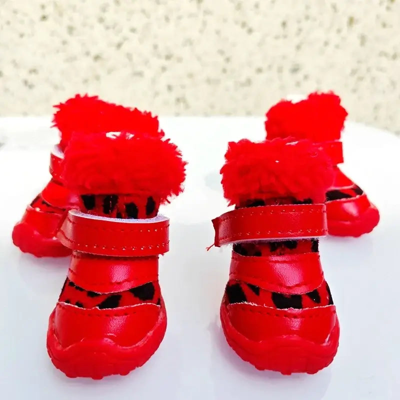 Winter leopard boots for small dogs in red with furry tops and Velcro straps, perfect for Chihuahua walking in snow.