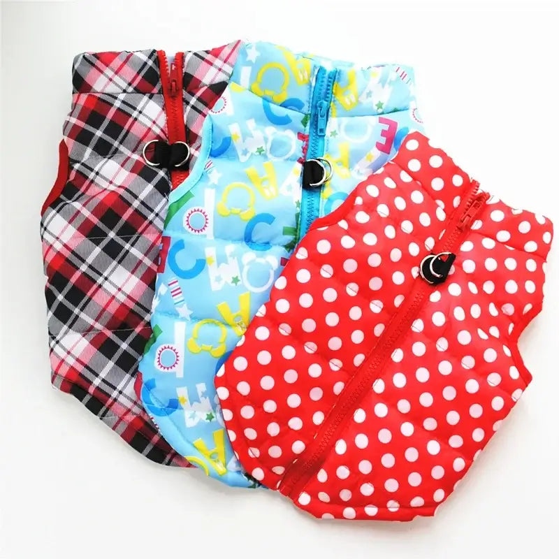 Three colorful windproof winter coat for dogs outfits in plaid, blue with letters, and red polka dots for pets.