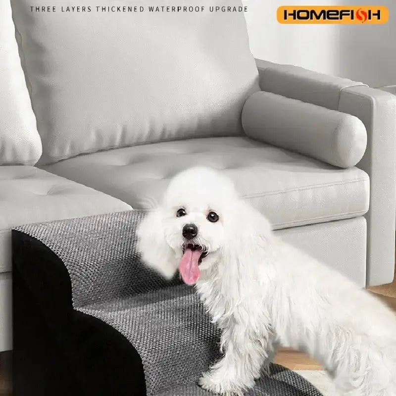Washable memory foam dog stairs with a fluffy white dog using the ramp next to a gray couch.