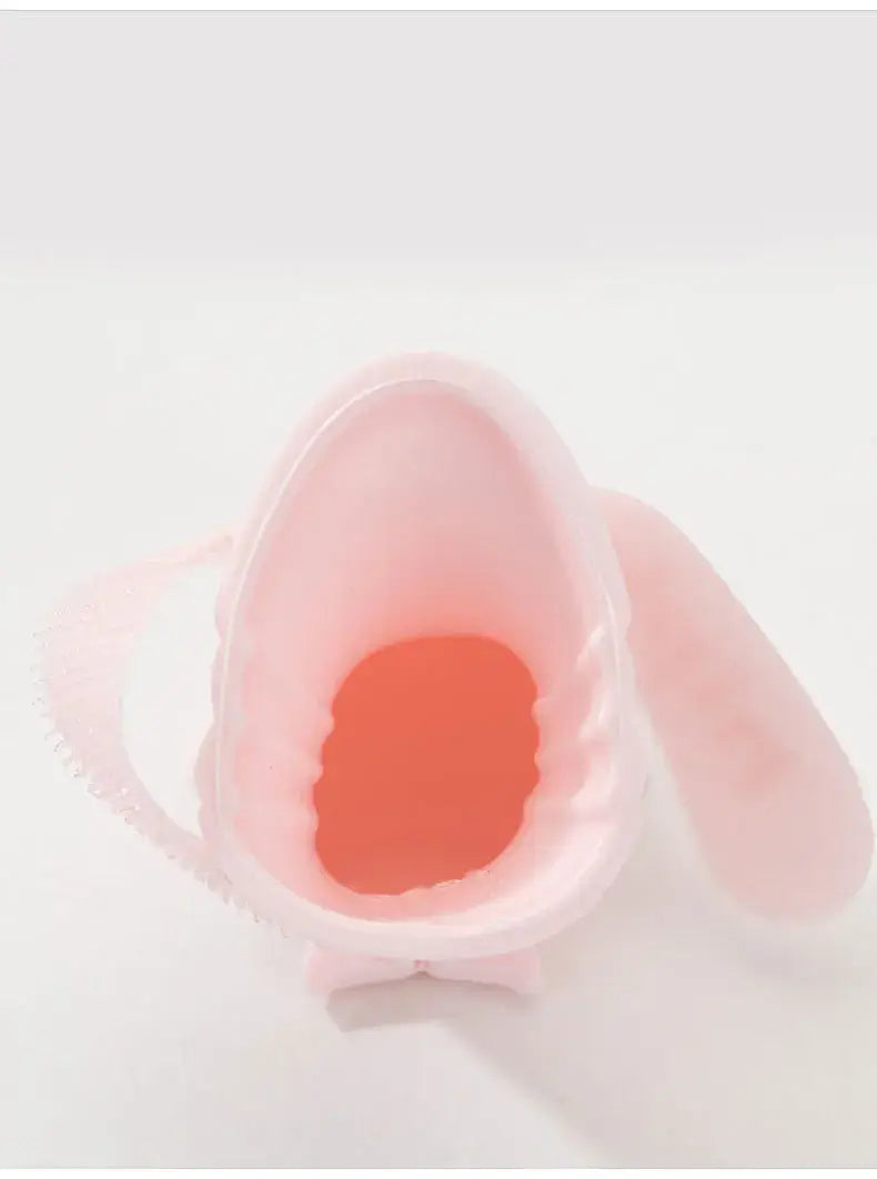 Pink silicone pet paw cleaning cup with soft brush, ideal for washing dog paws.