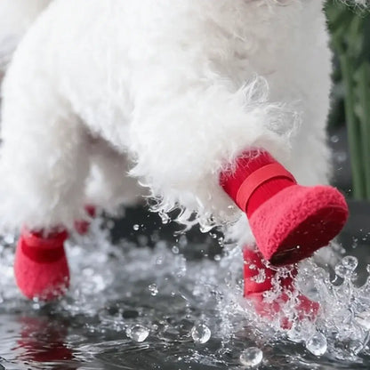 Red waterproof dog boots on a small white dog, non-slip, wear-resistant, and comfortable pet shoes for winter protection.